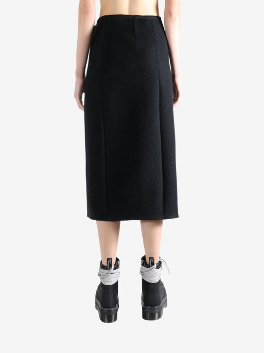 Black skirts worn by a person, showing the skirts fit