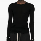 Black t-shirts worn by a person, showing the t-shirts fit