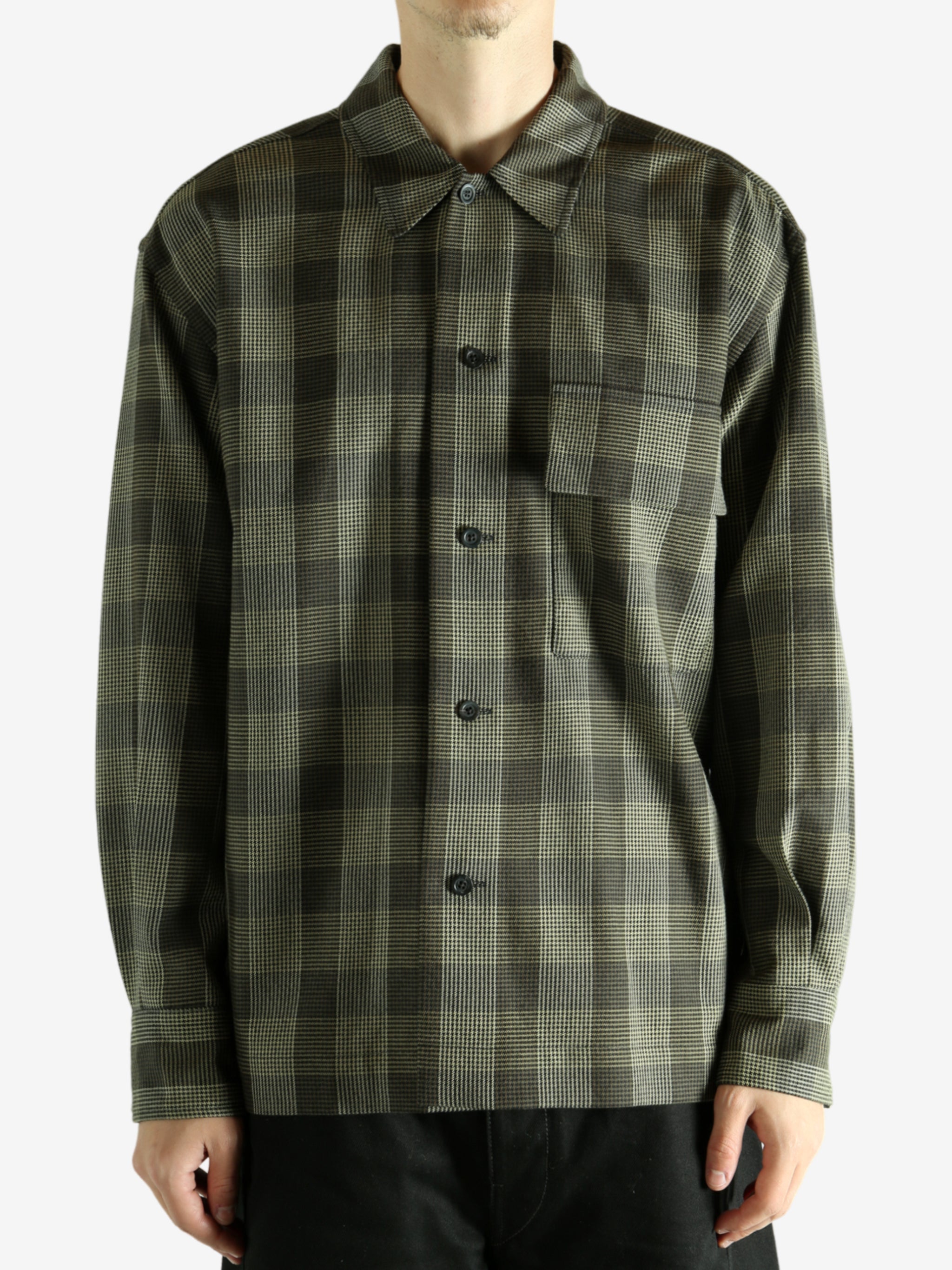 Black shirt worn by a person, showing the shirt's fit