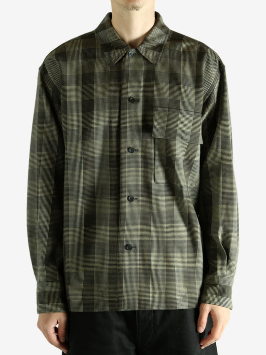 Black shirt worn by a person, showing the shirt's fit