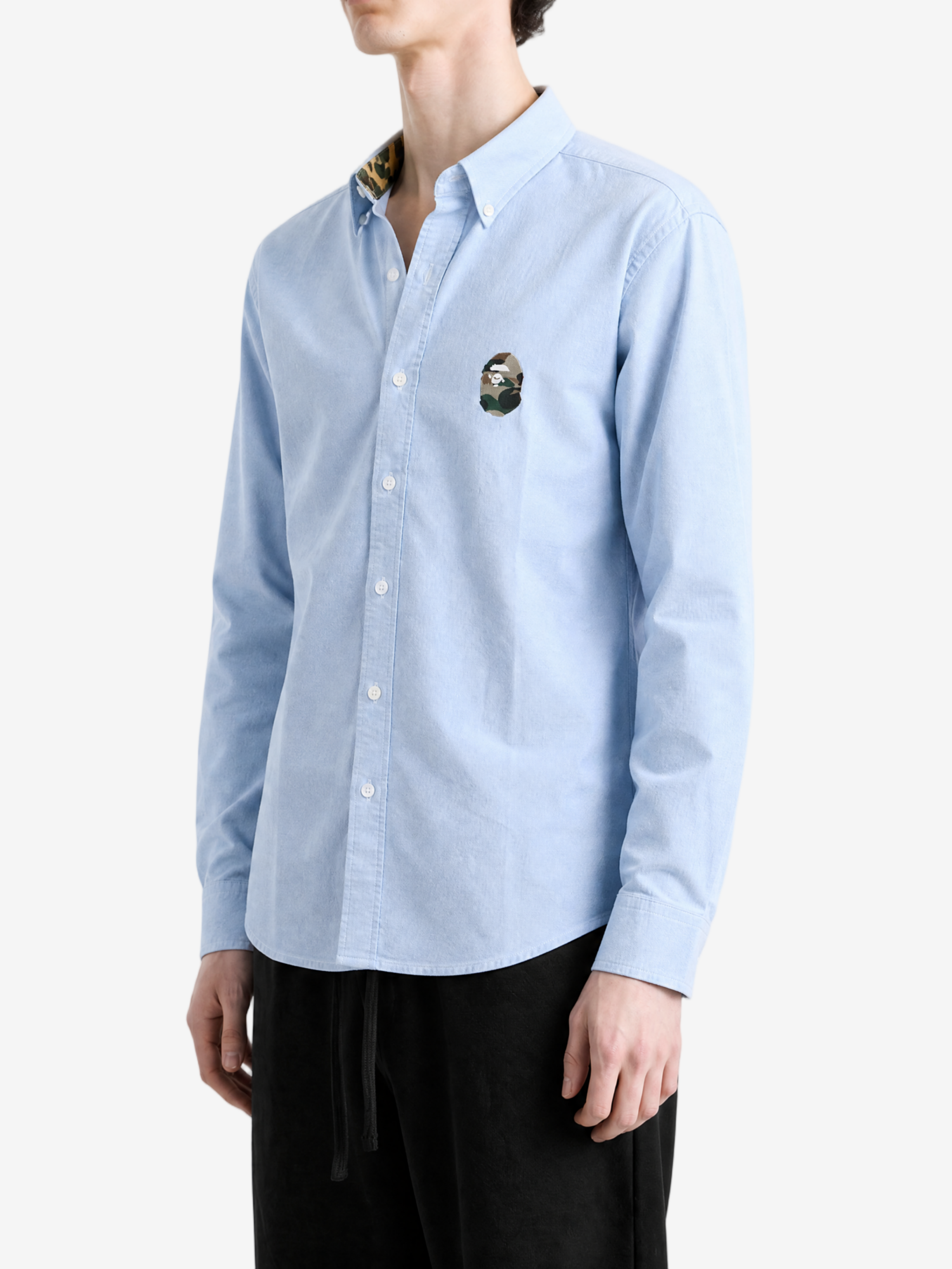 Blue shirt worn by a person, showing the shirt fit