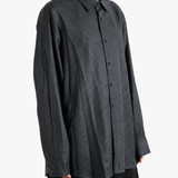 Grey shirt worn by a person, showing the shirt fit