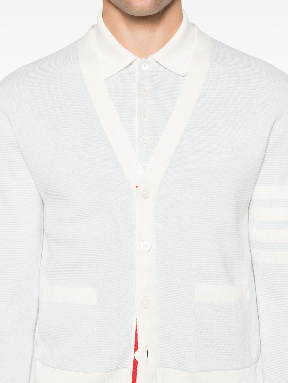 Blue knitwear worn by a person, showing the knitwear’s fit