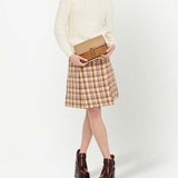 Tan bag carried by a person, showing the bag's fit