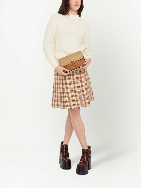 Tan bag carried by a person, showing the bag's fit