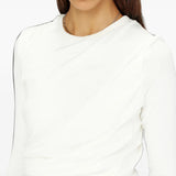 White top worn by a person, showing the top fit