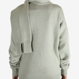 Green knitwear worn by a person, showing the knitwear fit