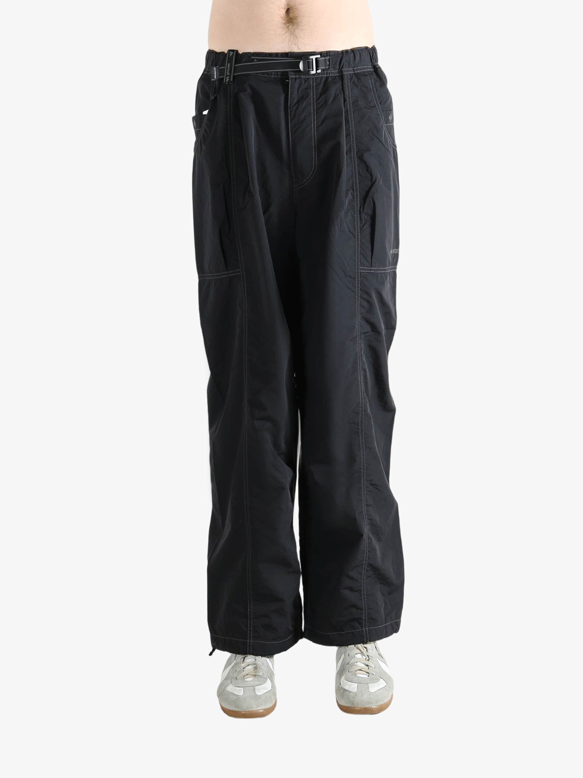 Black pants worn by a person, showing the pants fit