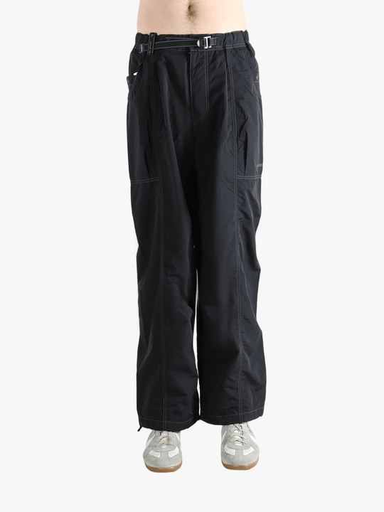 Black pants worn by a person, showing the pants fit