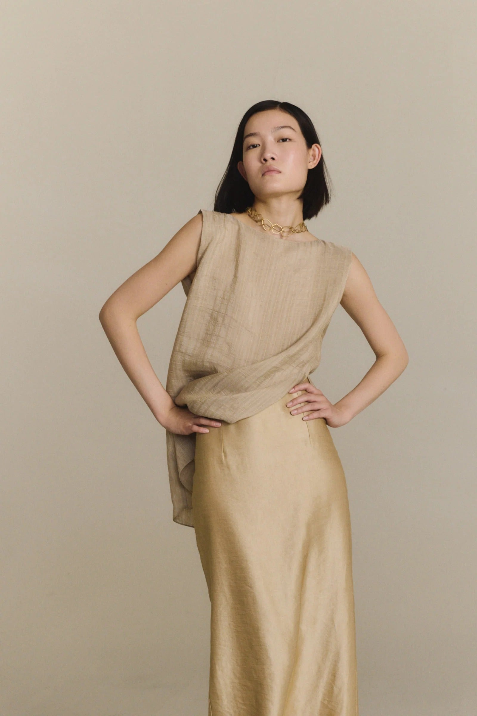 Tan top worn by a person, showing the top fit