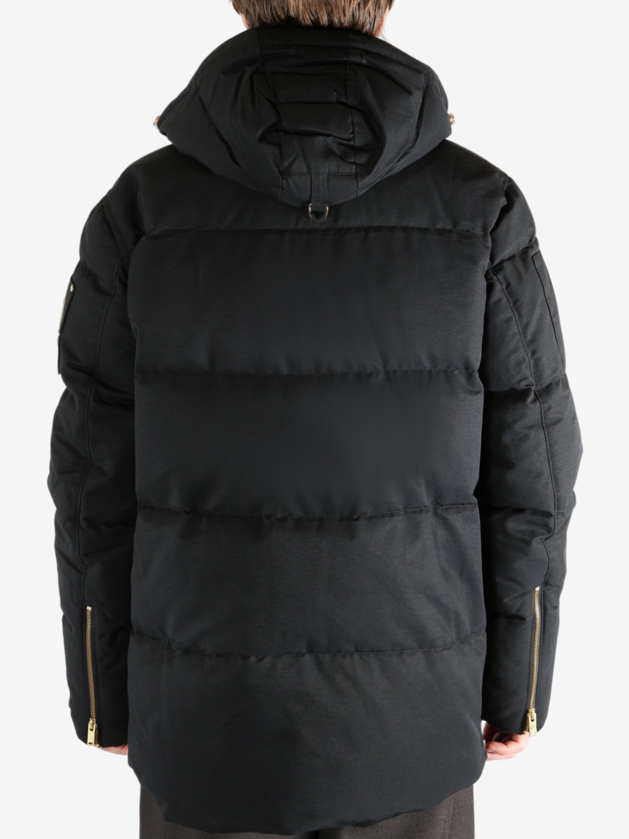 Black jacket worn by a person, showing the jacket's fit