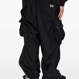 black pants worn by a person, showing the pants fit