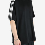 Black t-shirt worn by a person, showing the shirt's fit