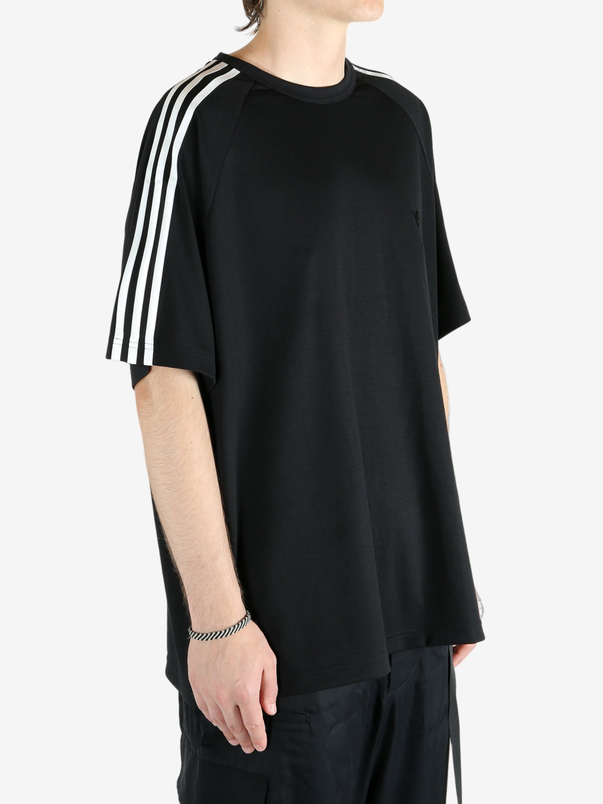 Black t-shirt worn by a person, showing the shirt's fit