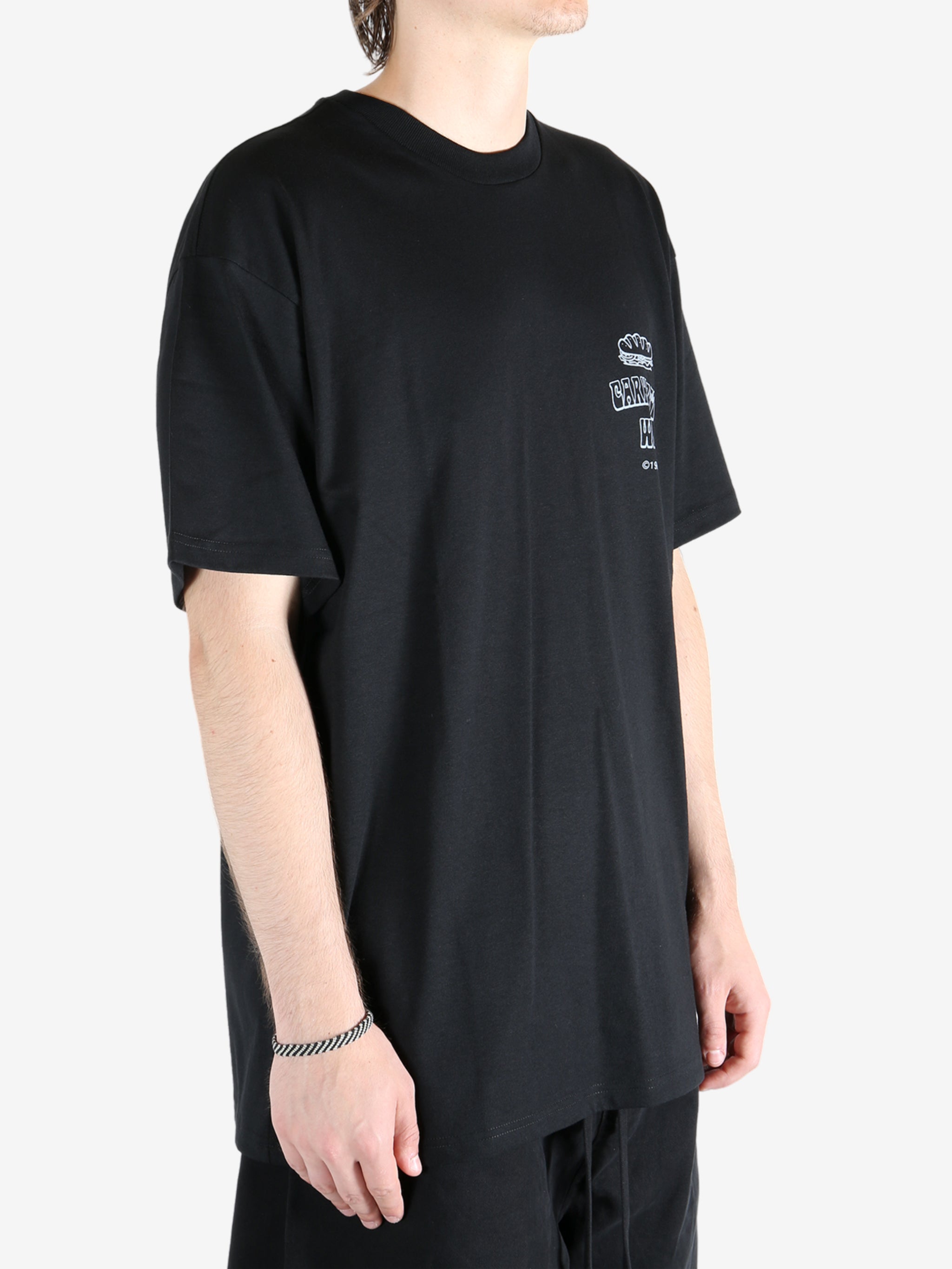 Black t-shirt worn by a person, showing the t-shirt's fit