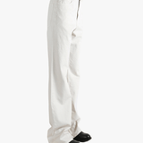 White pant worn by a person, showing the pant's fit