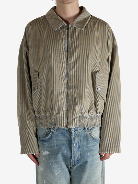 Tan jacket worn by a person, showing the jacket’s fit