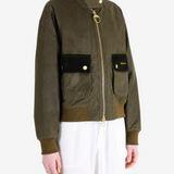 Green jacket worn by a person, showing the jacket fit