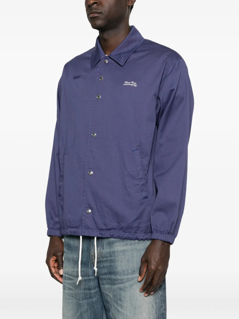Purple jacket worn by a person, showing the jacket fit