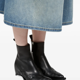 Black boot worn by a person, showing the boot 's fit