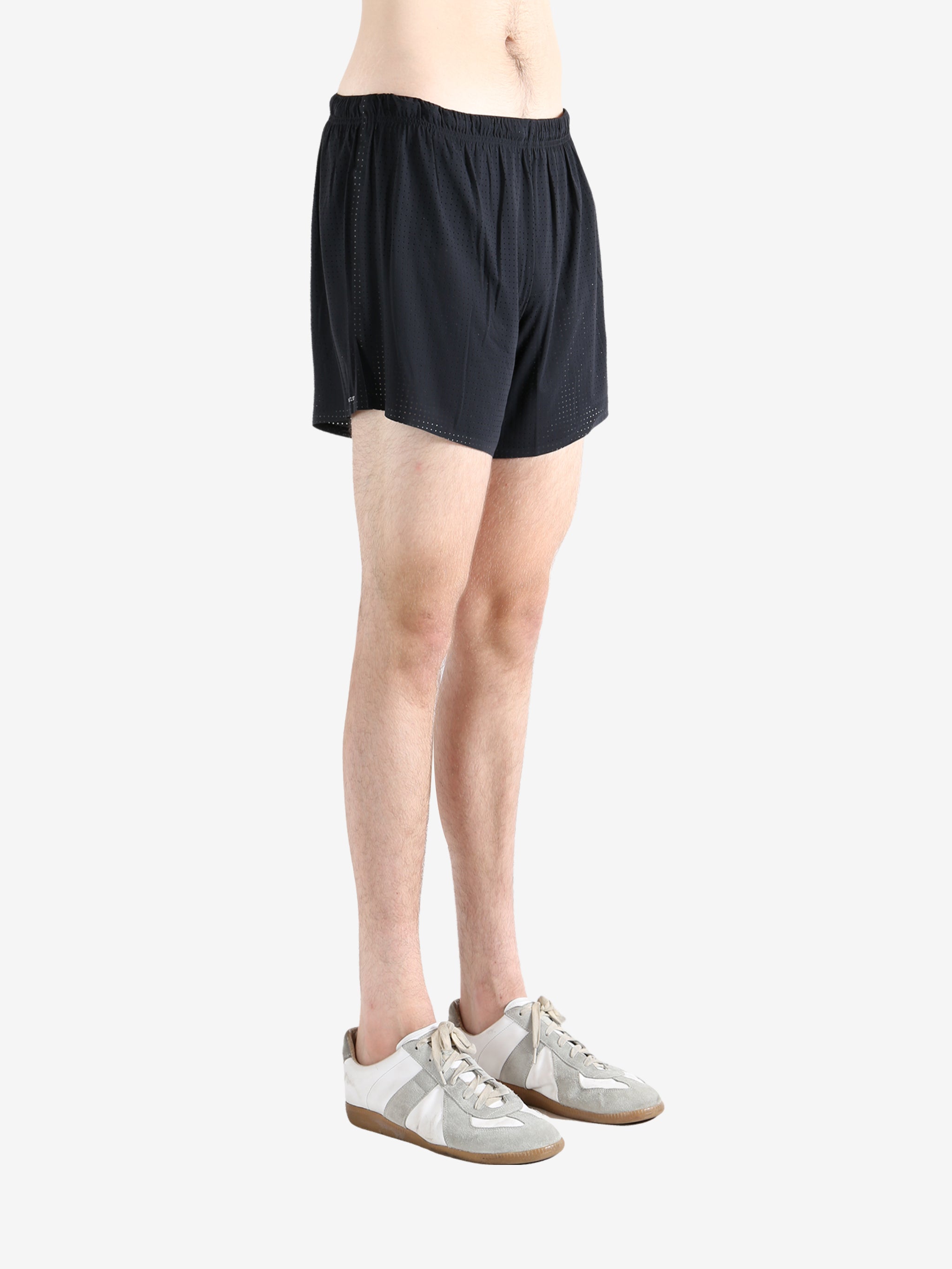 Black shorts worn by a person, showing the shorts' fit