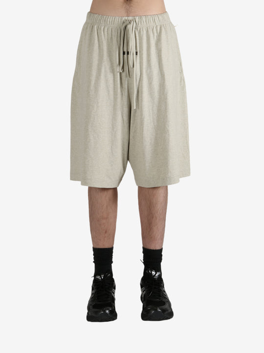 Grey shorts worn by a person, showing the shorts fit