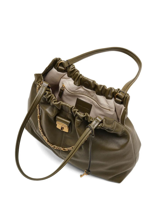 Close up of the green bag, showing texture of the leather fabric