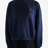 Navy knitwear worn by a person, showing the knitwear fit