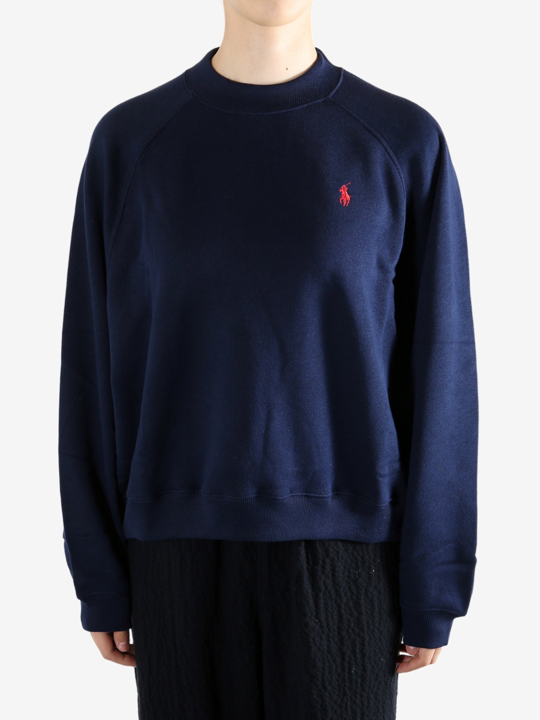 Navy knitwear worn by a person, showing the knitwear fit