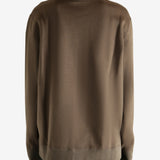 Brown knitwear worn by a person, showing the knitwear fit