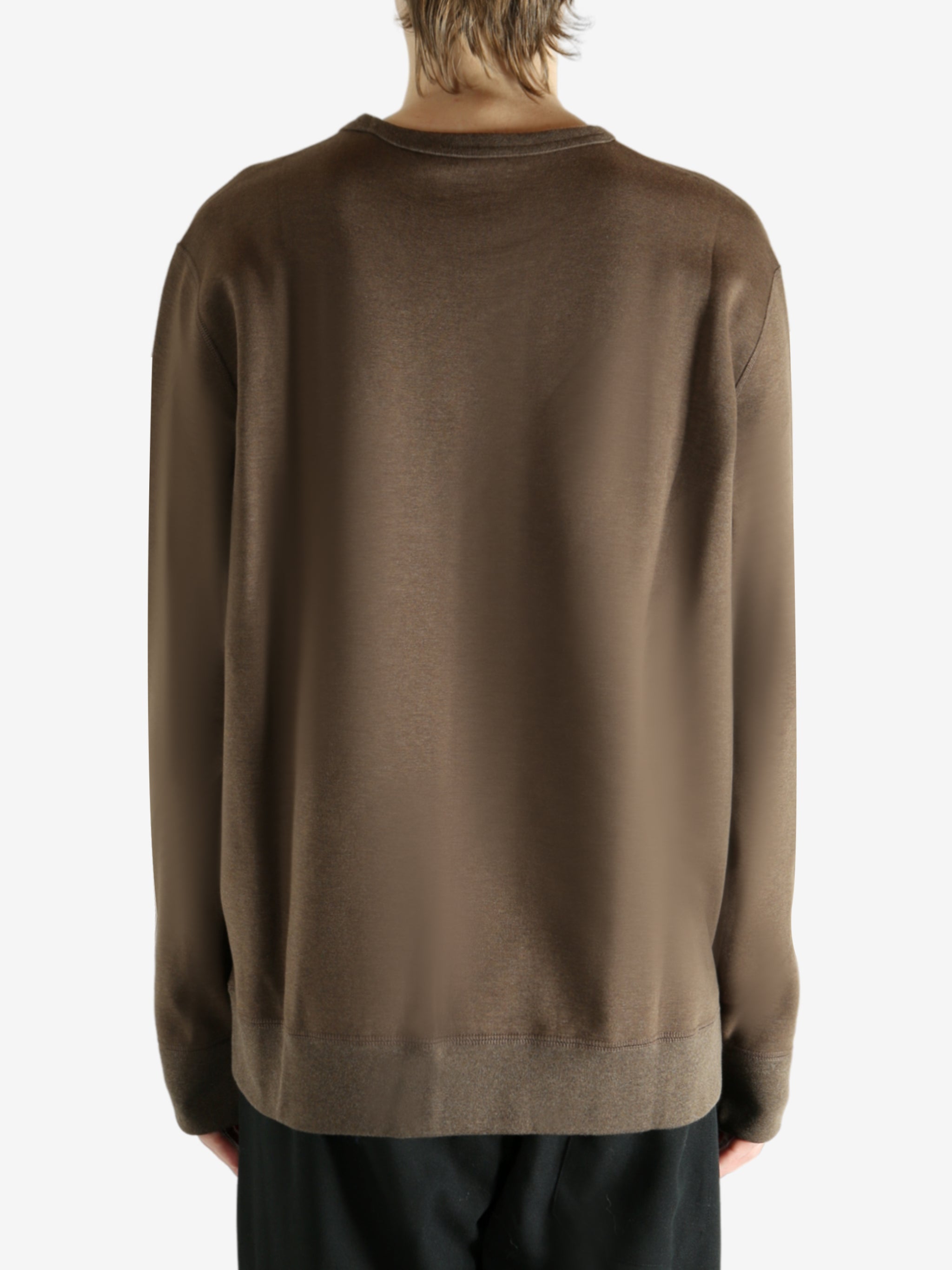 Brown knitwear worn by a person, showing the knitwear fit