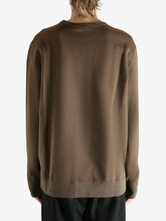 Brown knitwear worn by a person, showing the knitwear fit