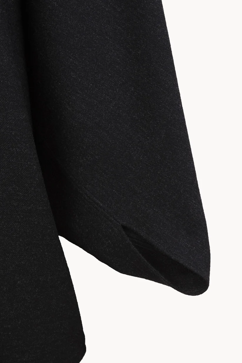 Close up of Black jacket, showing texture of the 100% wool fabric