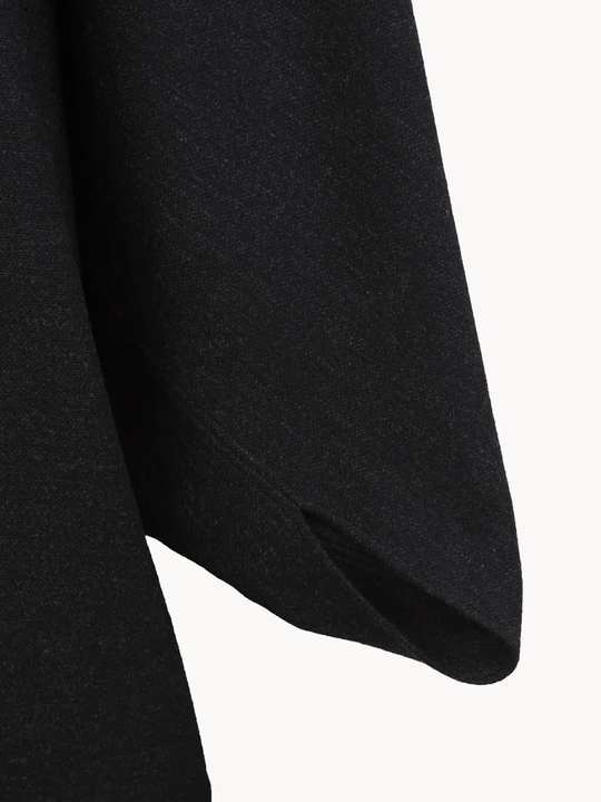 Close up of Black jacket, showing texture of the 100% wool fabric