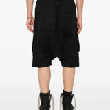 Black short worn by a person, showing the short's fit