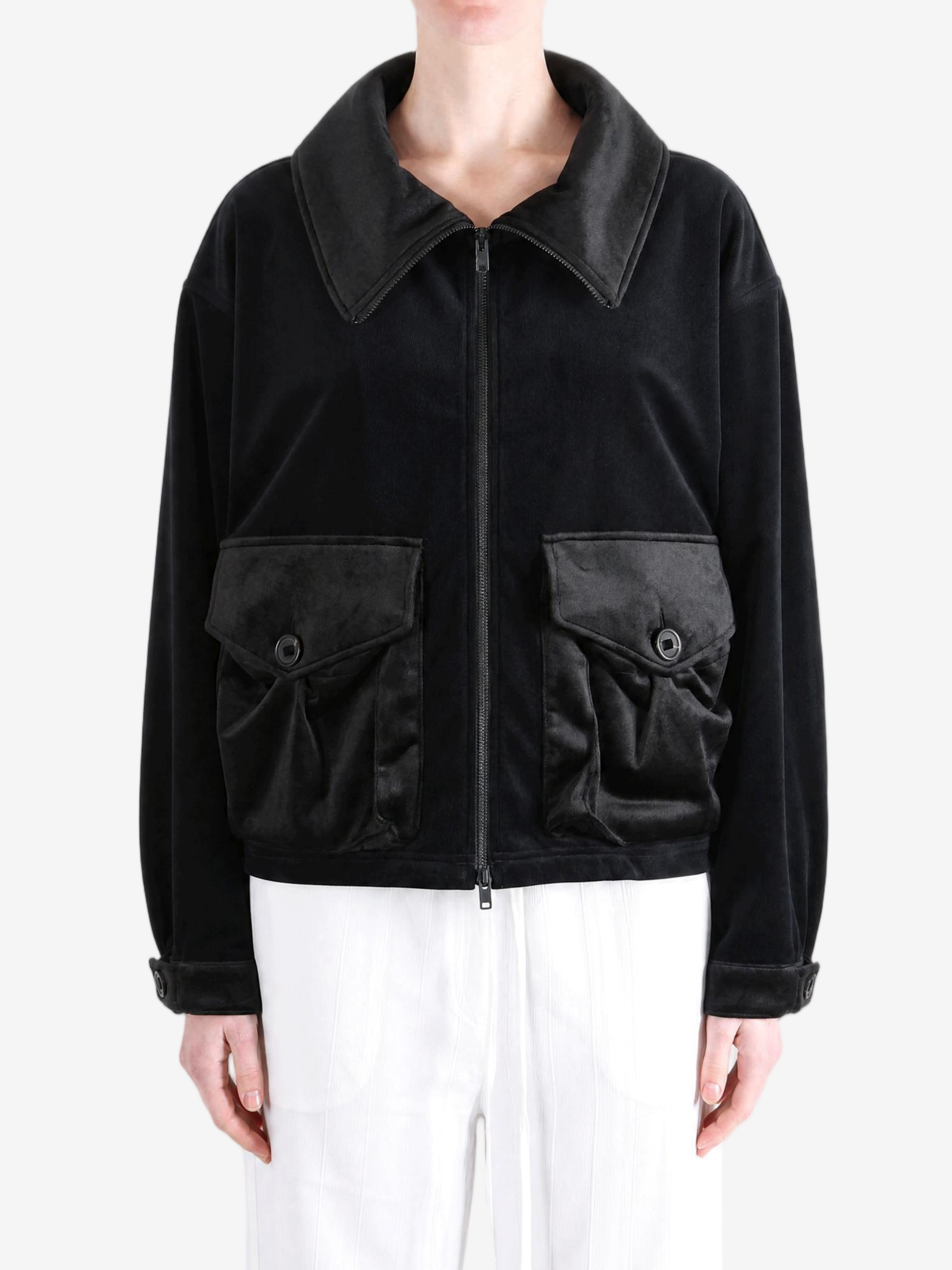 Black jacket worn by a person, showing the jacket fit