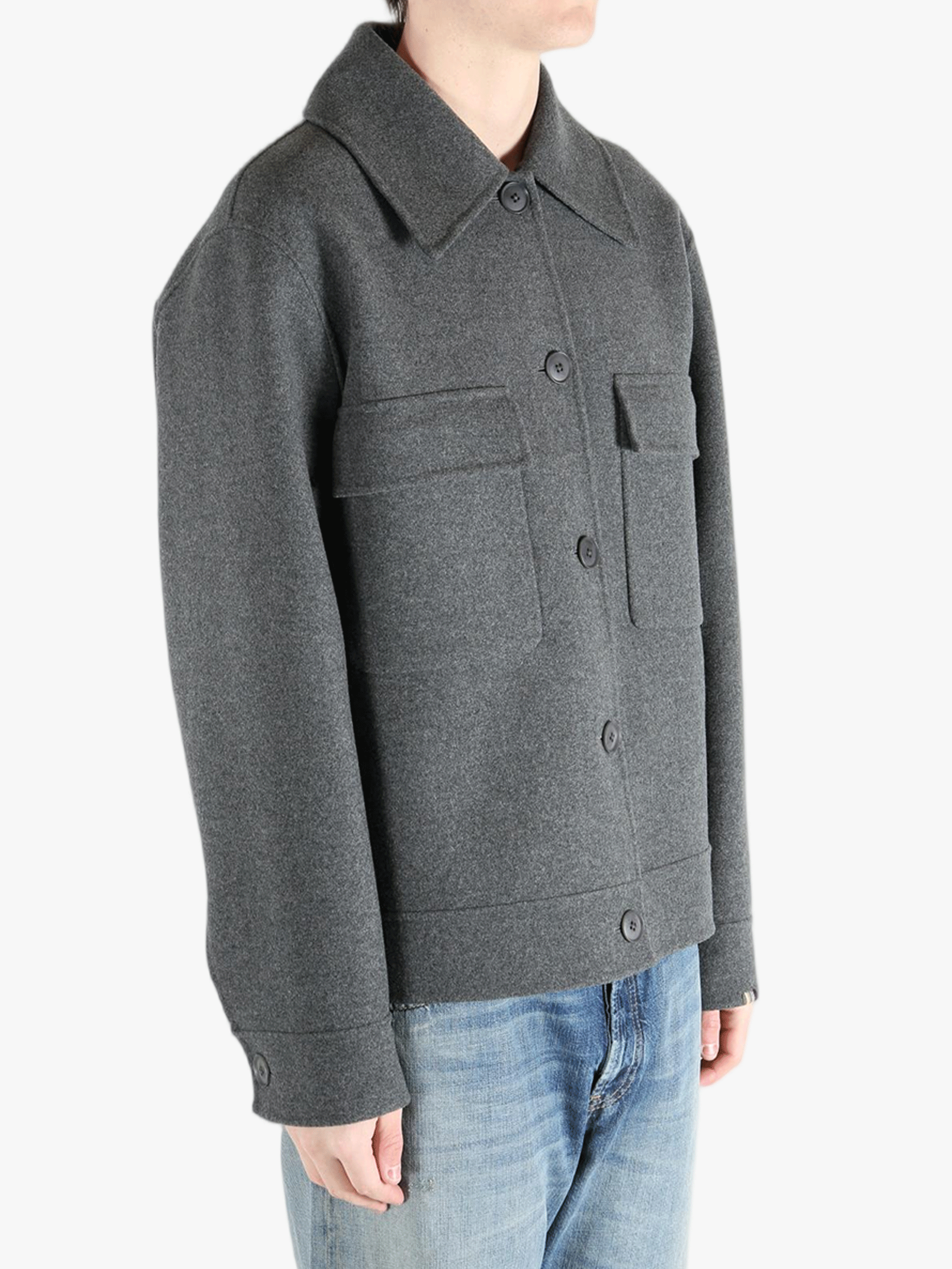 Grey jacket worn by a person, showing the pants fit