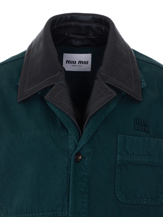 Close up of green coats, showing texture of the gabardine fabric