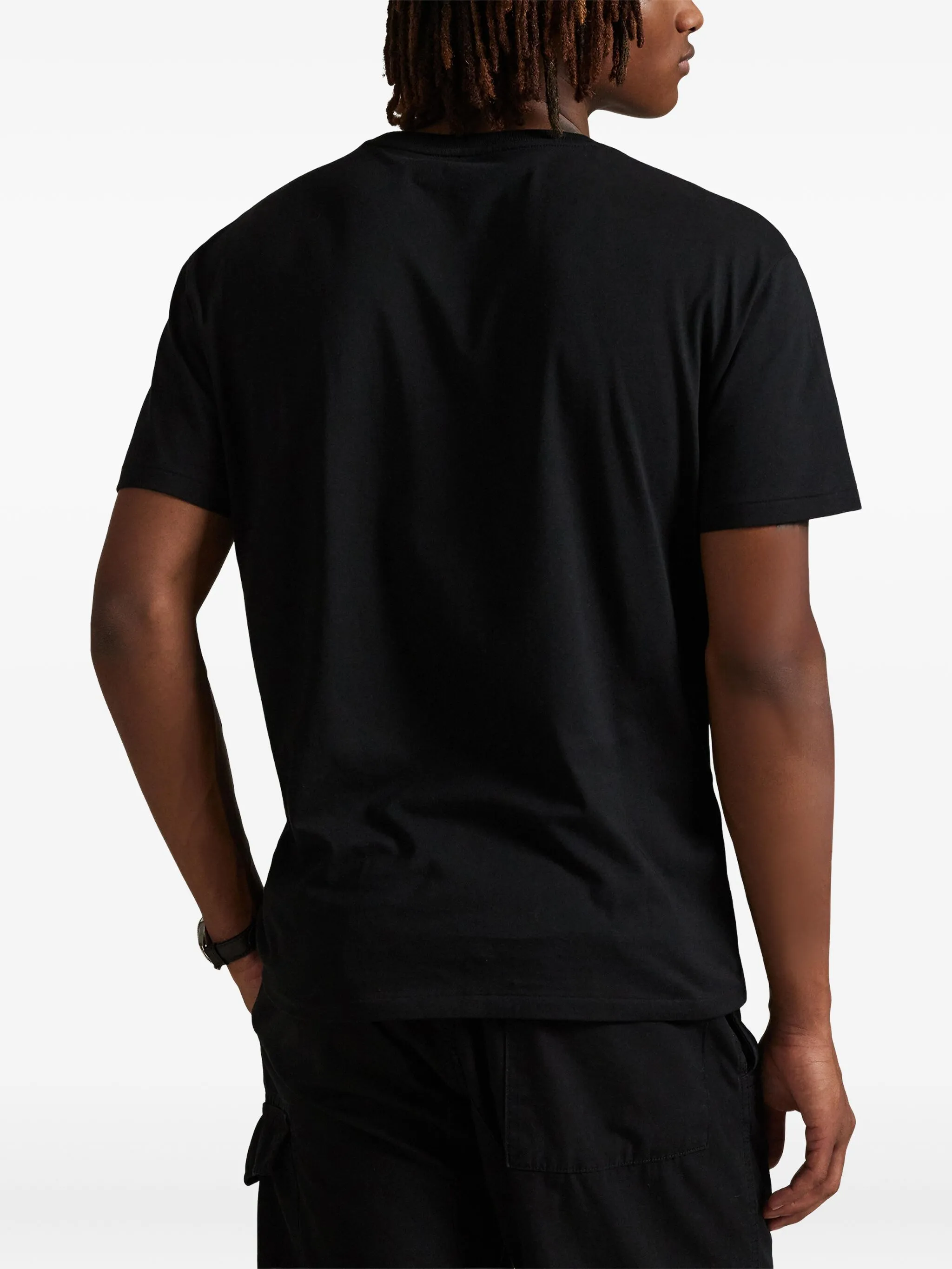 black t-shirt worn by a person, showing the t-shirt fit