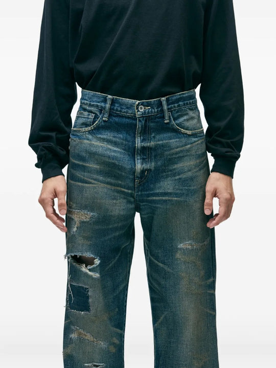 Blue pants worn by a person, showing the pants's fit