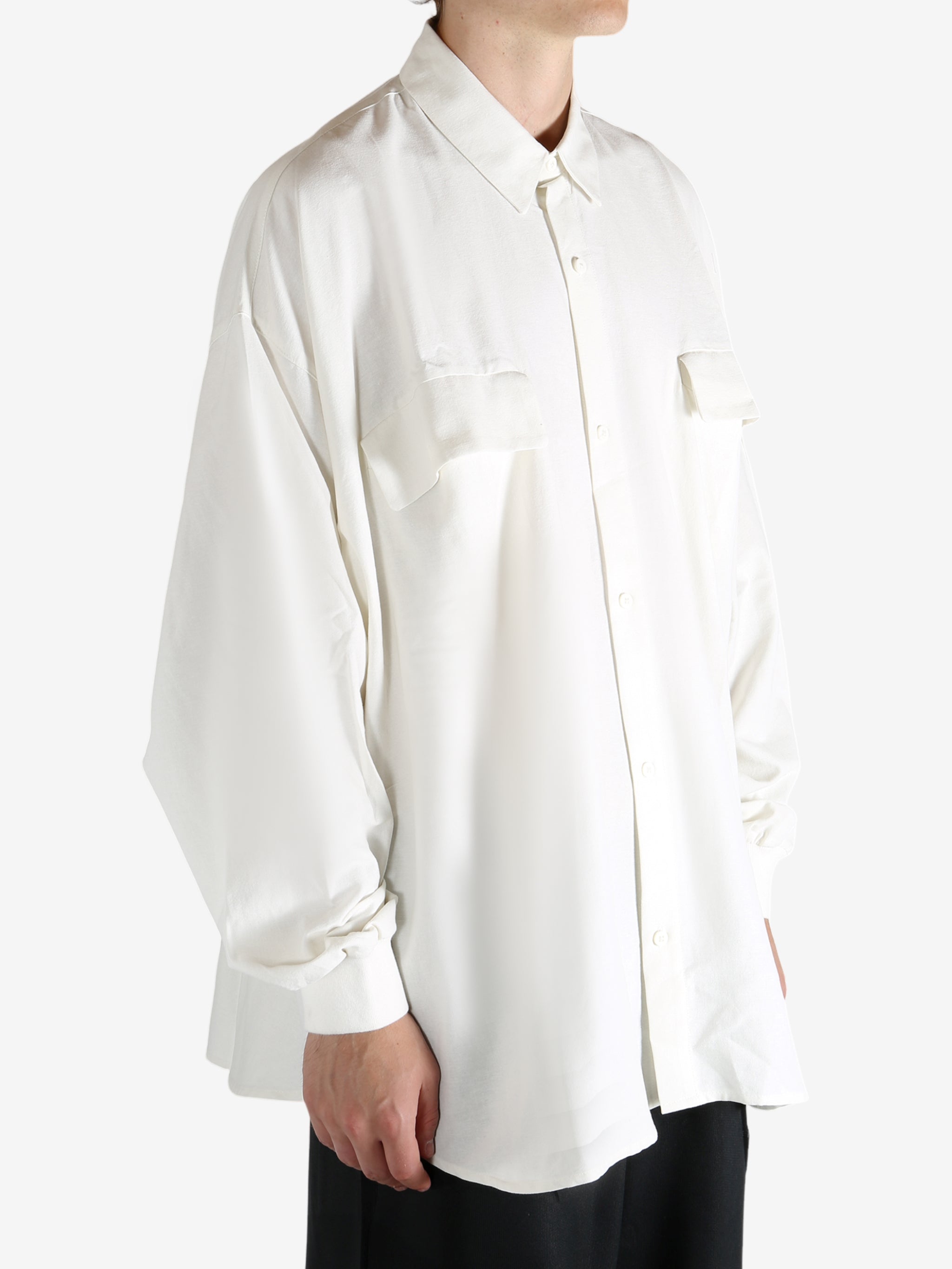 White shirt worn by a person, showing the shirt's fit
