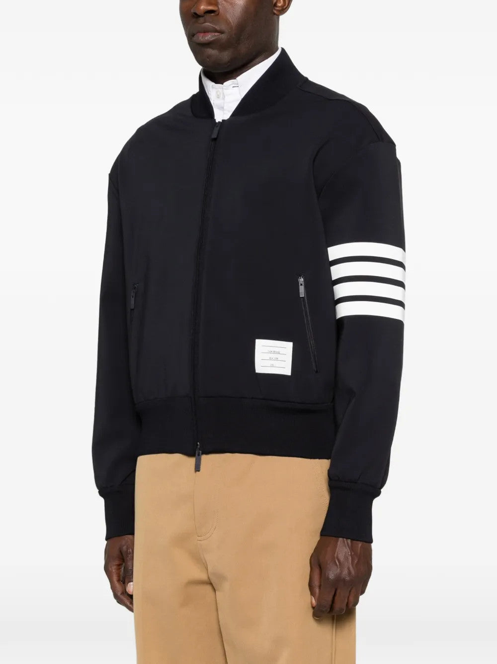 Black jacket worn by a person, showing the jacket fit