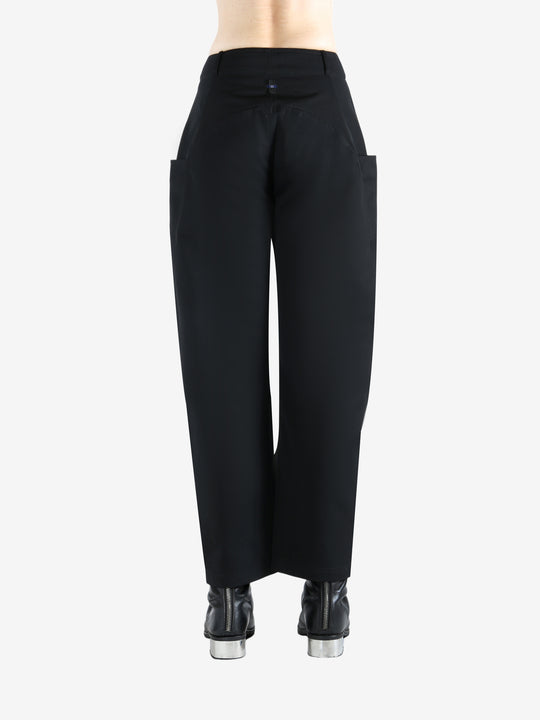 Black pants worn by a person, showing the pants' fit