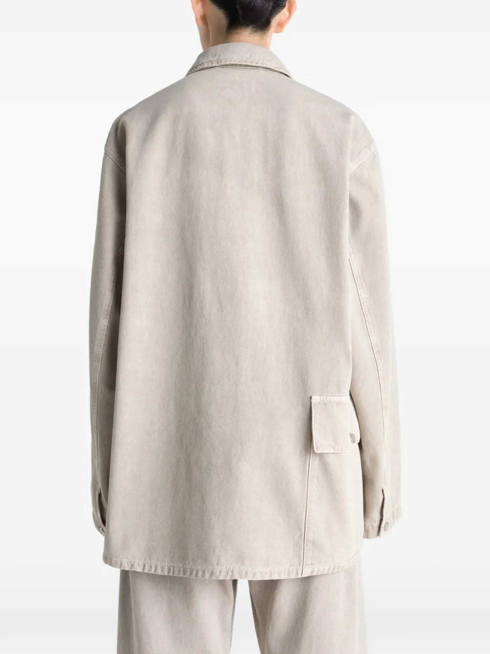 White shirt worn by a person, showing the shirt's fit
