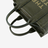 Close up of green bag, showing texture of the leather fabric