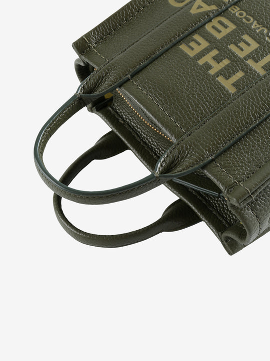 Close up of green bag, showing texture of the leather fabric