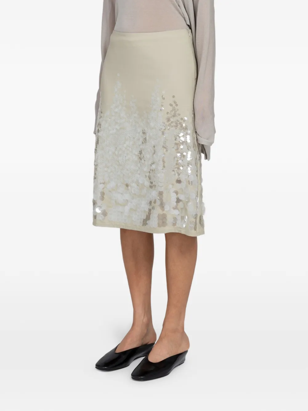 Tan skirts worn by a person, showing the skirts fit