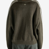 Brown sweater worn by a person, showing the sweater's  fit