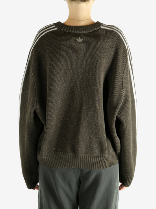 Brown sweater worn by a person, showing the sweater's  fit
