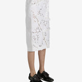 White skirt worn by a person, showing the skirt fit